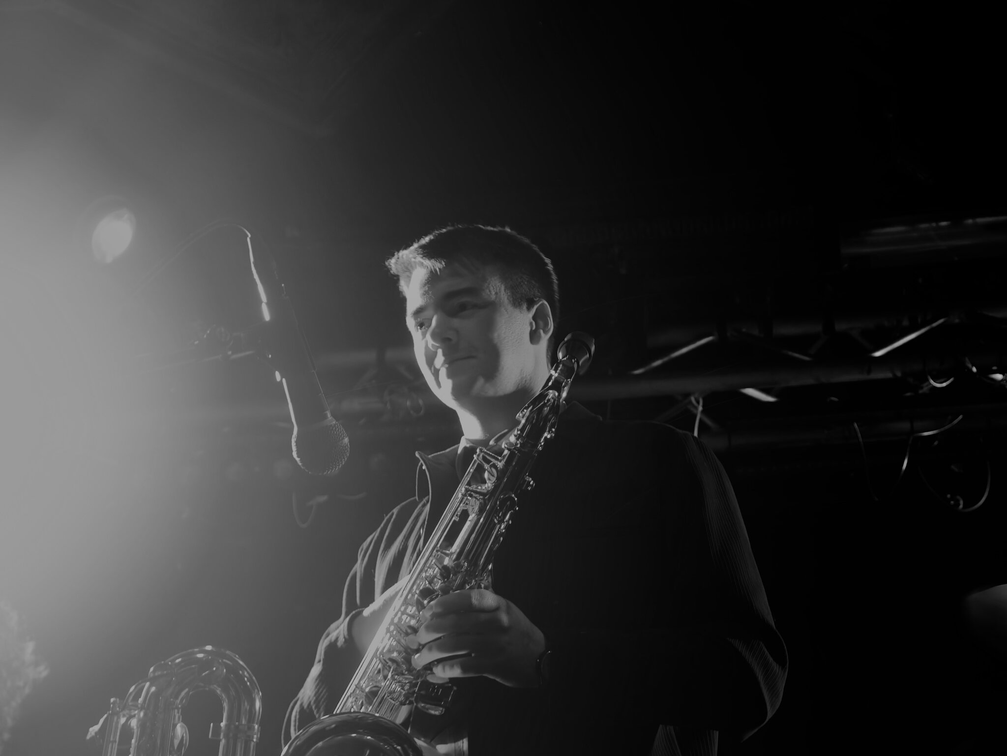 Black and white shot of the saxophonist mid-performance