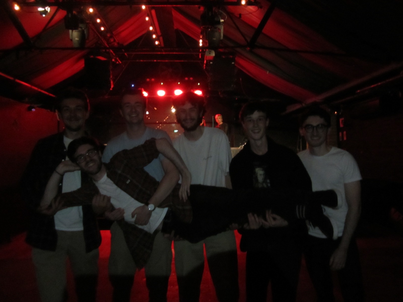 The full six-piece on stage after a show